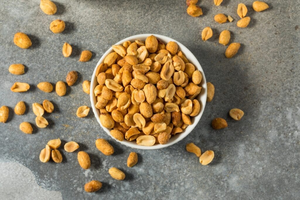 Peanuts in a white ceramic bowl.