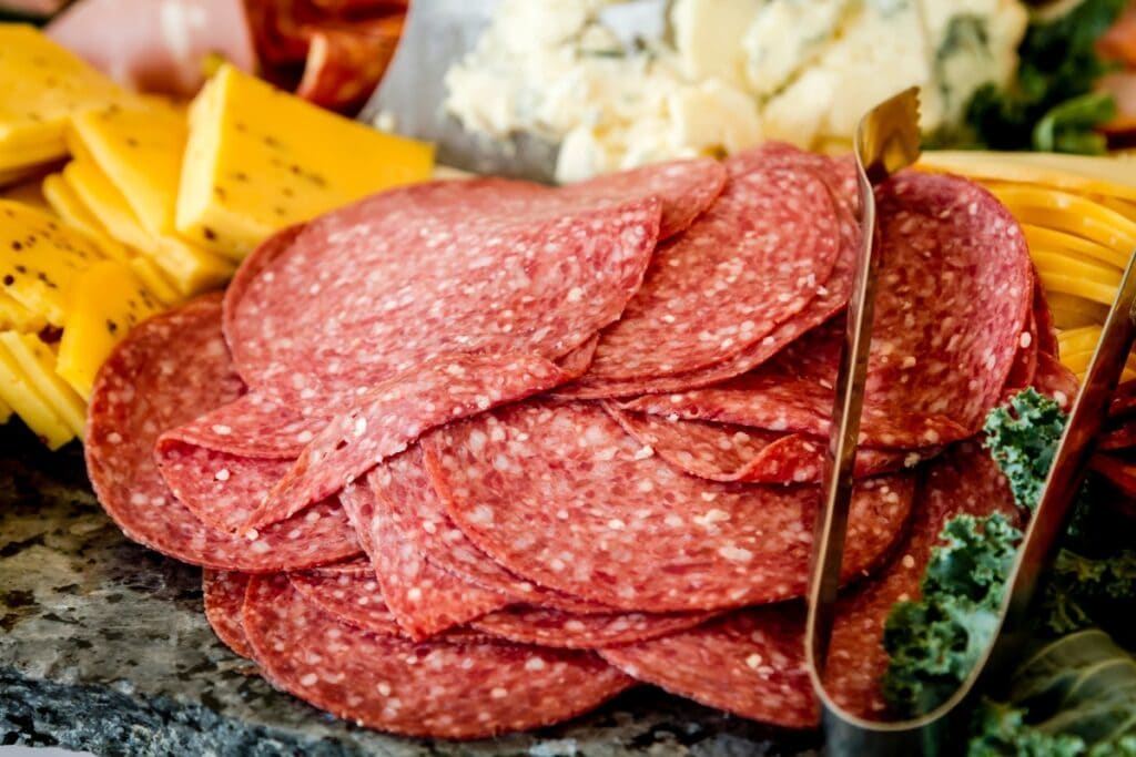 Slices of pepperoni and cubed cheese.