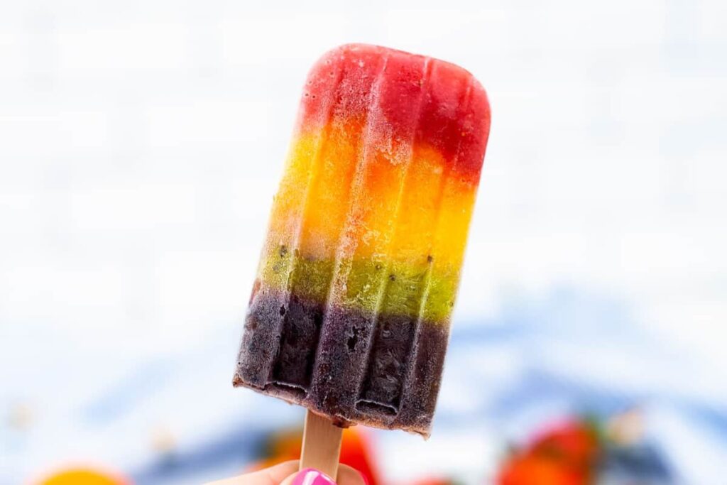 Rainbow popsicle on a white background.