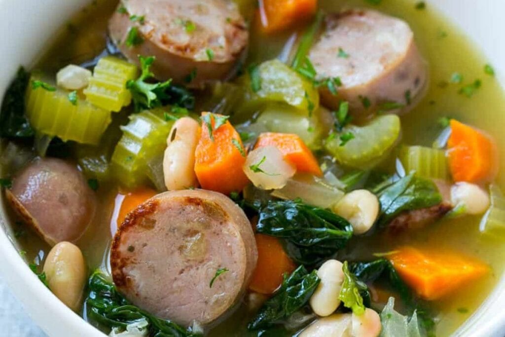 Close up shot of sausage and white bean soup.
