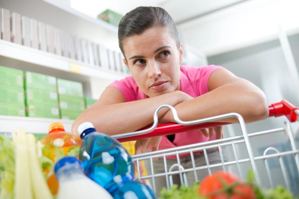 Tired woman shopping for groceries.