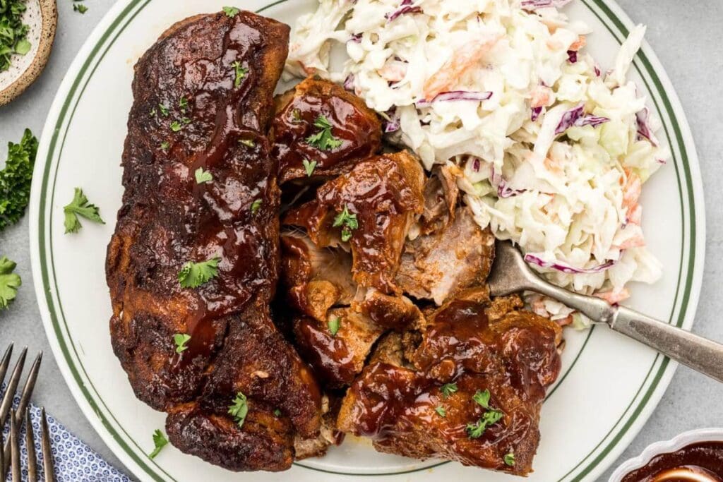 Barbecue ribs with coleslaw on a plate.