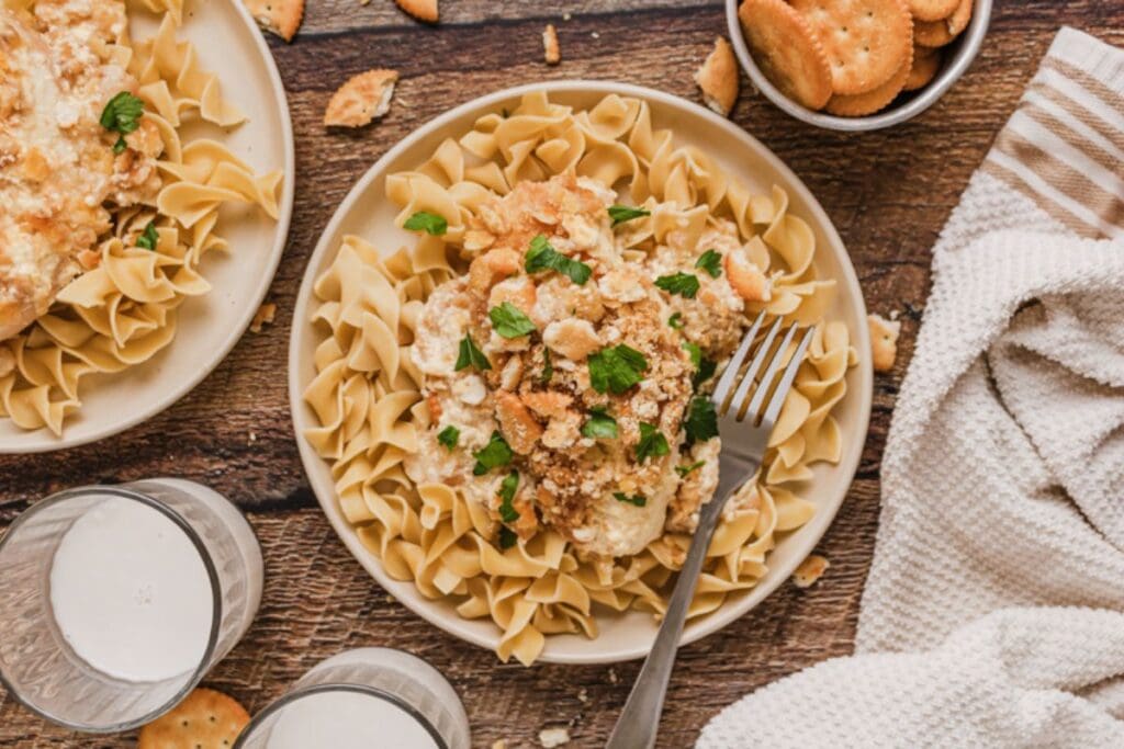 Pasta with chicken on top.