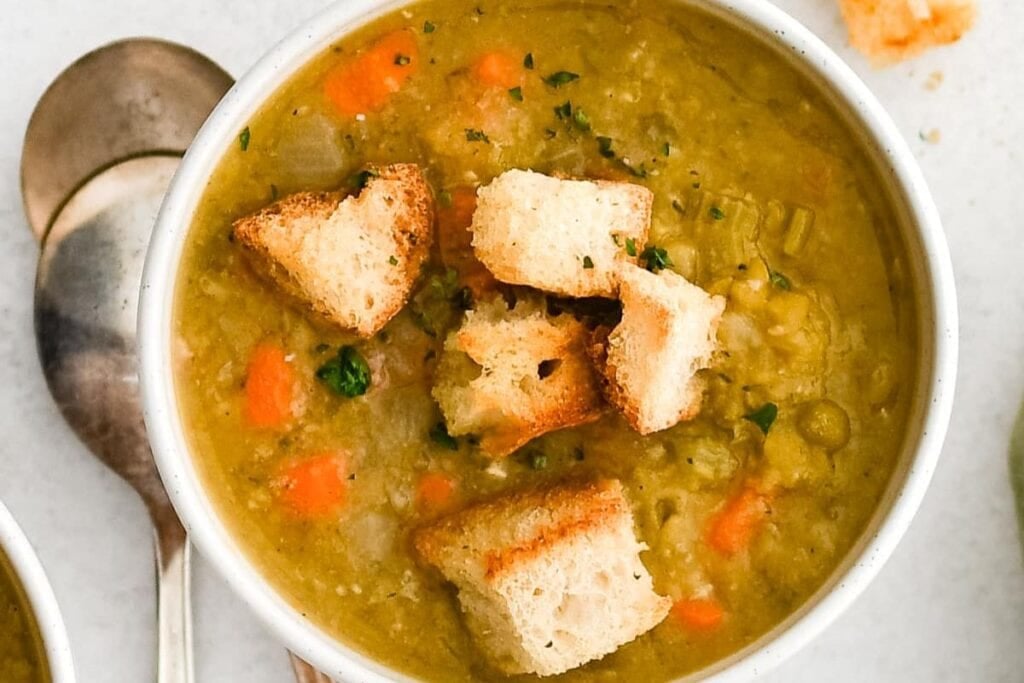 A bowl of split soup with ham.