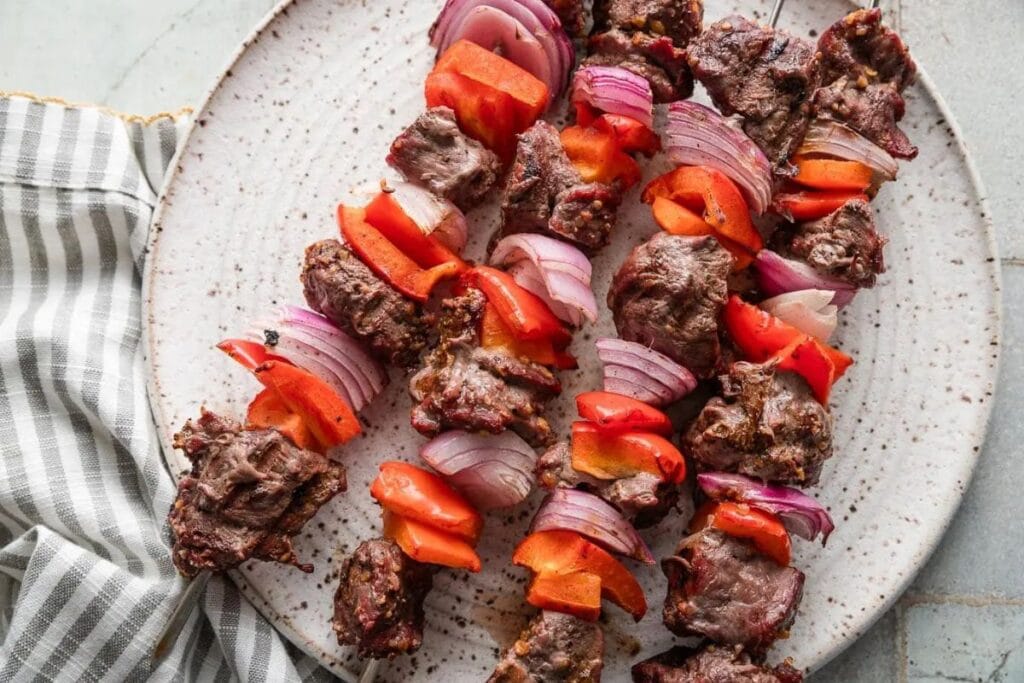 Steak kabobs on a plate.