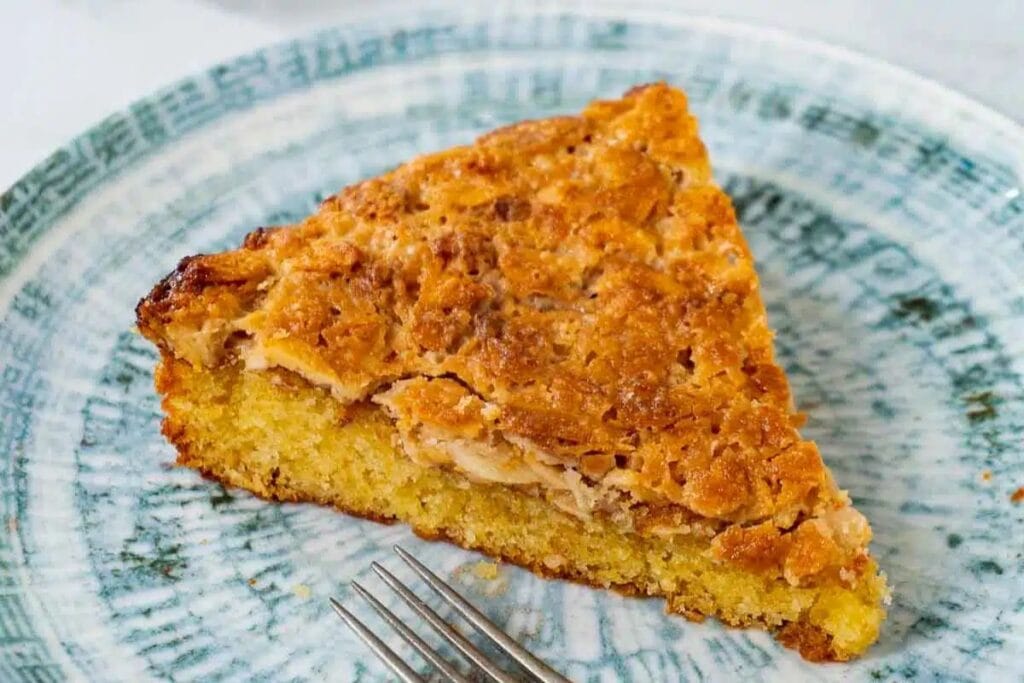 A slice of almond cake on a plate.