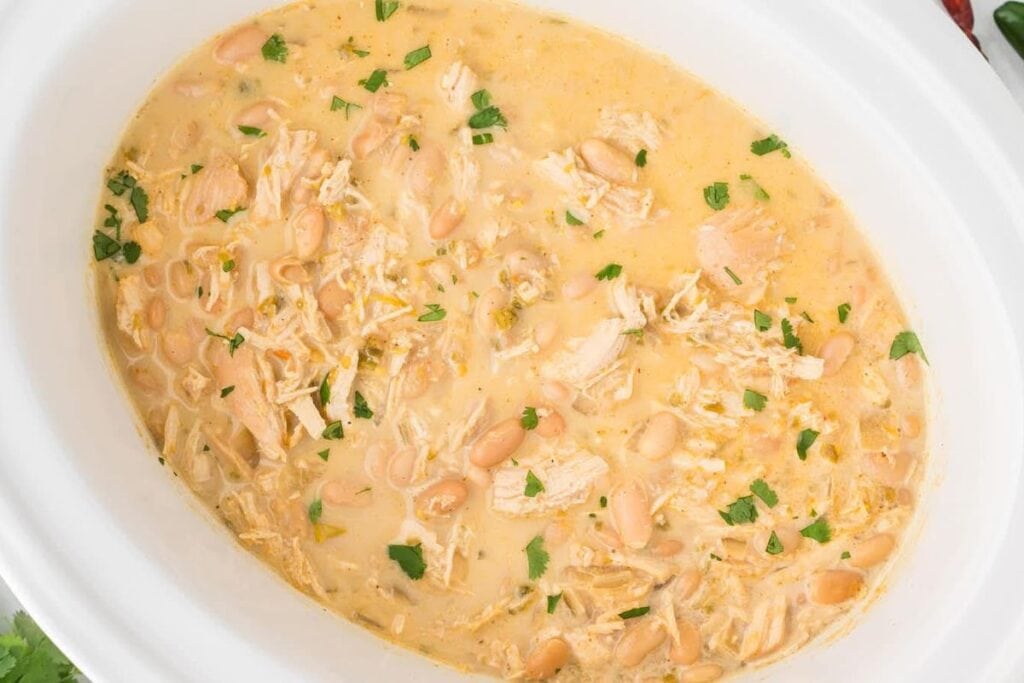 Chicken chili in a white deep bowl.