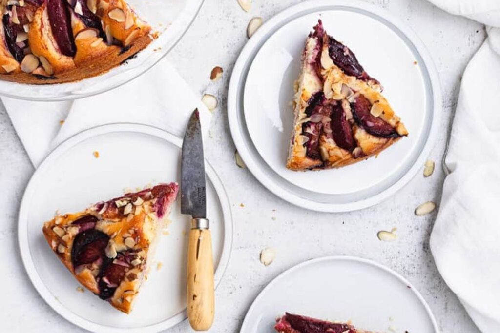 Two plates of sliced plum cakes.