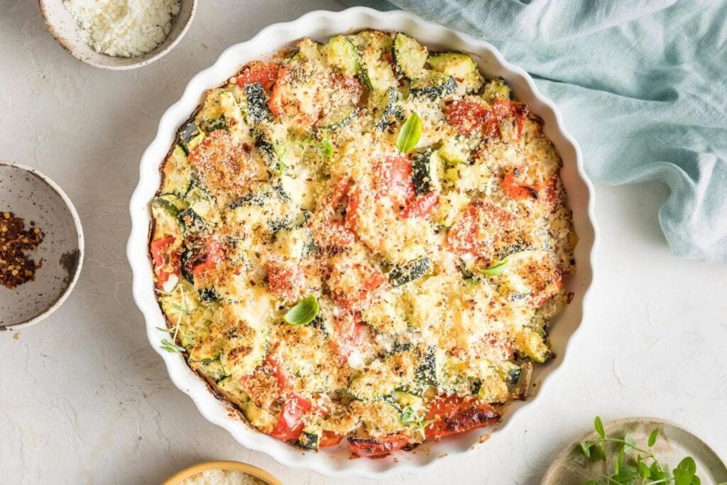 Zucchini casserole on a white surface.