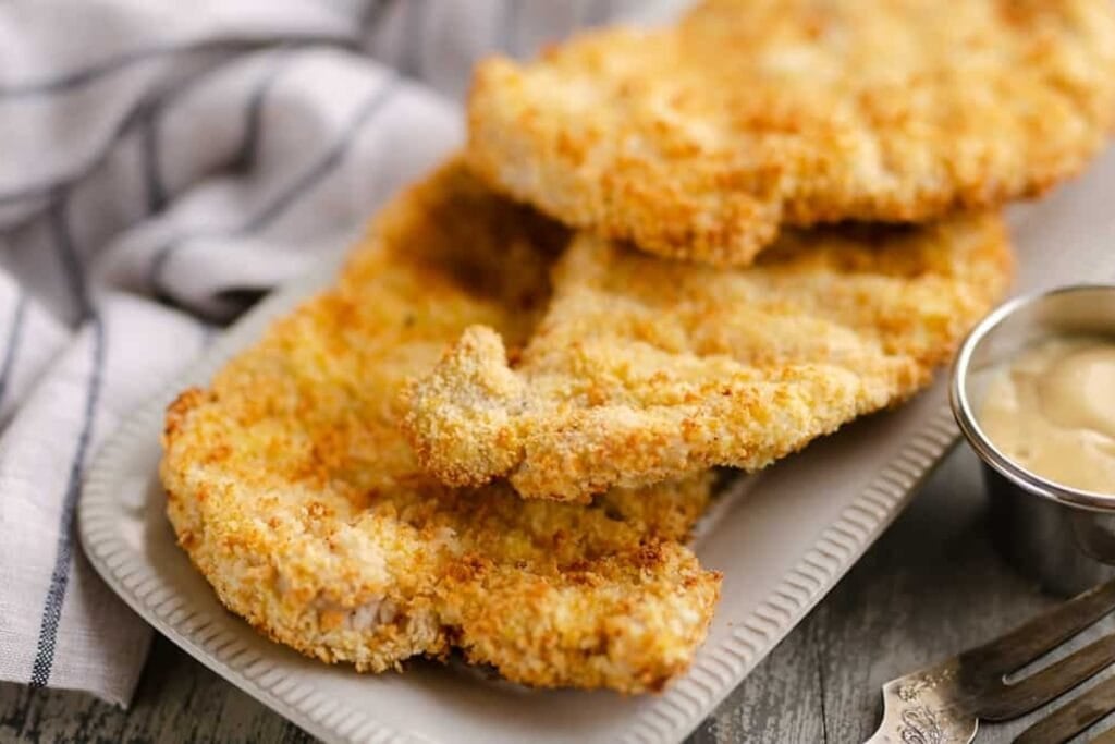 Air fryer breaded pork chops served on a plate.