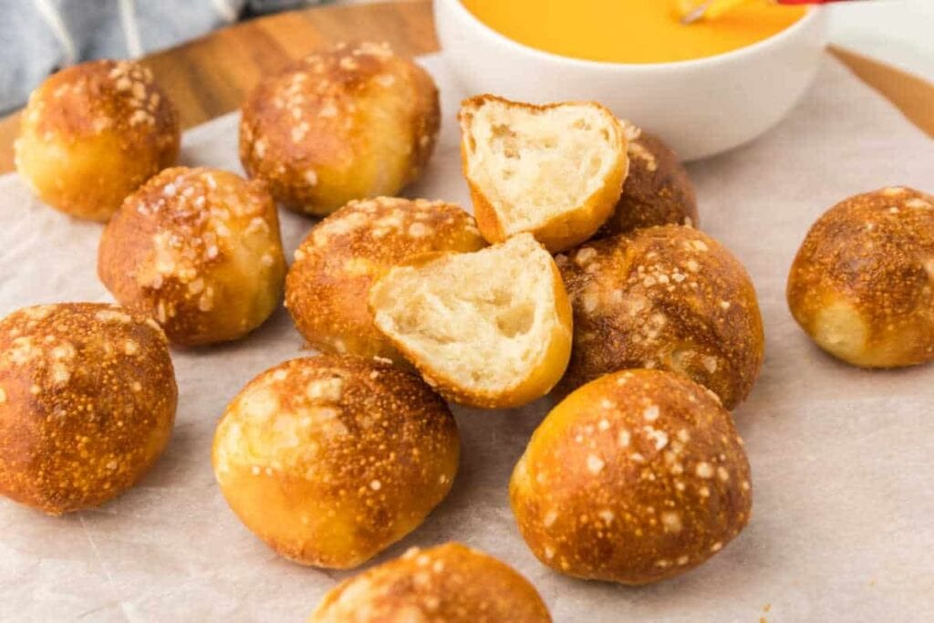 Air fryer pretzel bites on a wooden board.