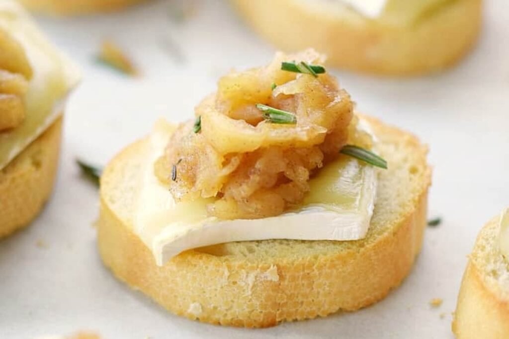 Apple Compote Brie Crostini on a white plate.