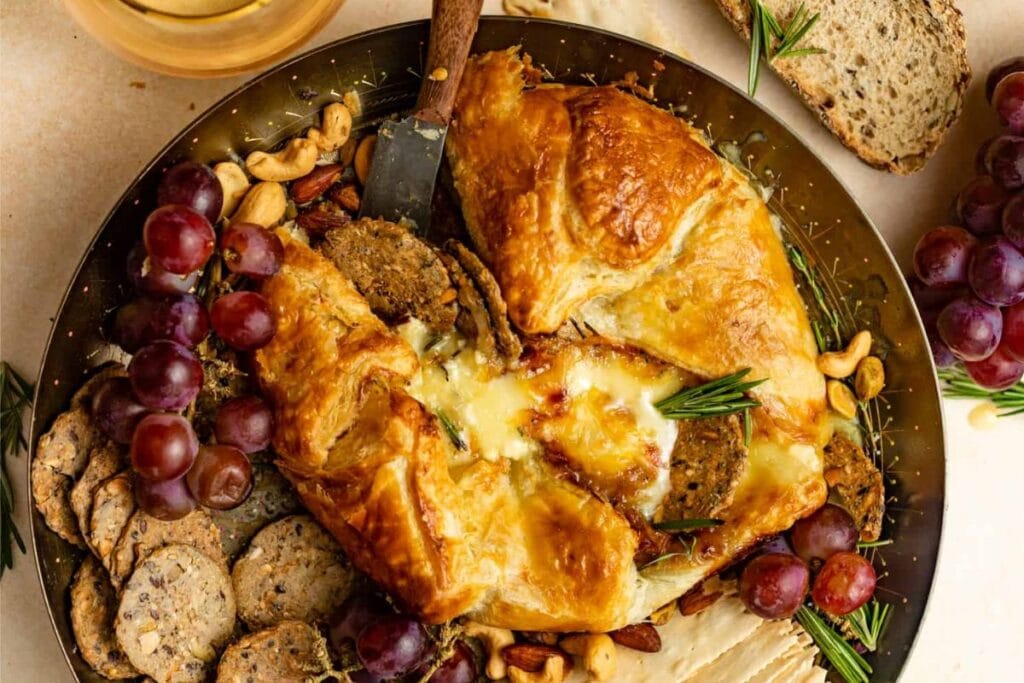 Baked Brie Puff Pastry in a skillet with knife.