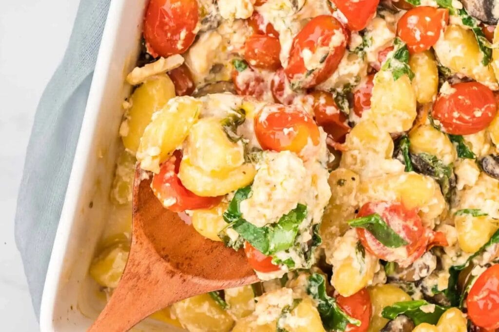 Baked feta cheese gnocchi in a white baking dish.