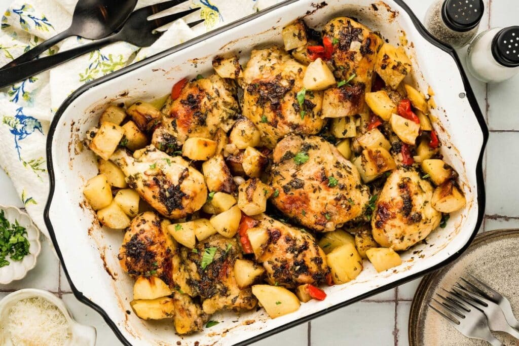 Baked Italian chicken with potatoes in a rectangular baking dish.