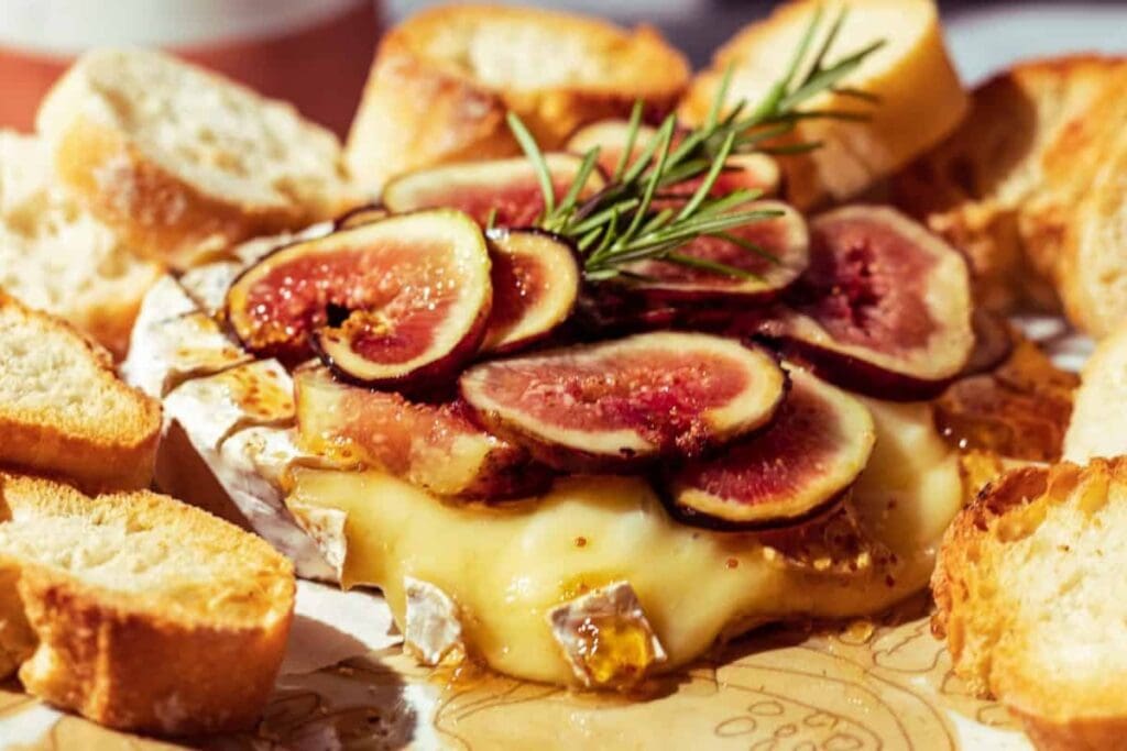 Baked brie with fig slices and rosemary, served with toasted baguette.