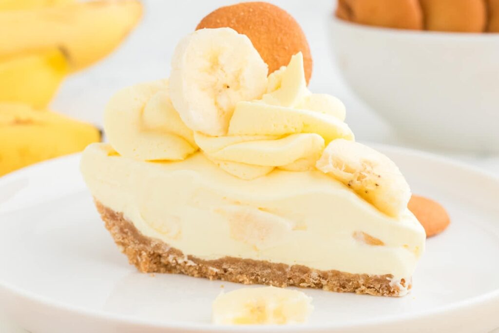 Banana cream pie on a white plate.