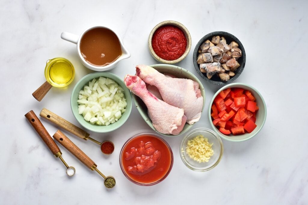 Best Chicken Cacciatore ingredients on a white marble table.