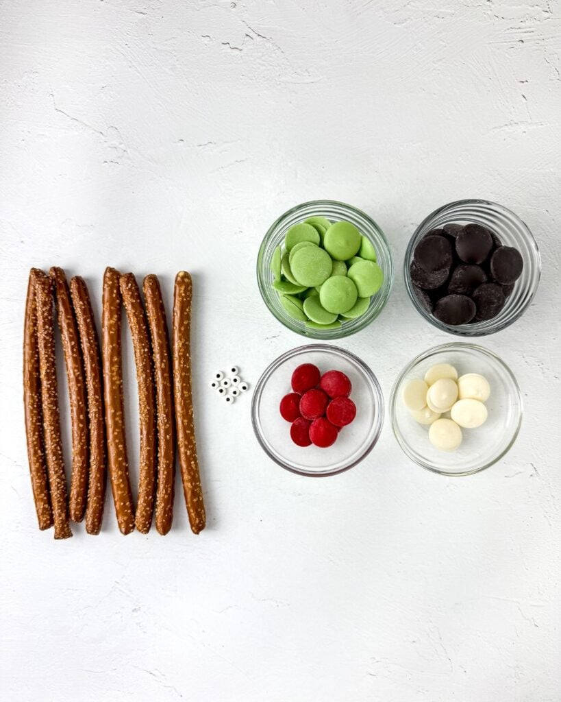 Ingredients for Bride of Frankenstein Halloween pretzel rods laid out on a white surface.