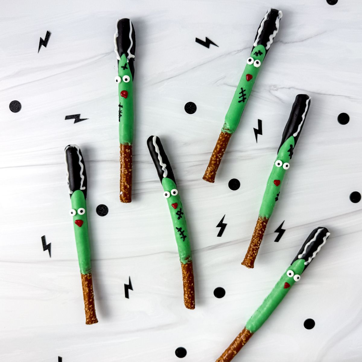 Bride of Frankenstein pretzel rods on marble counter.
