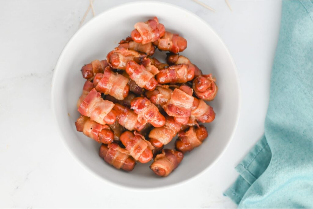 Brown sugar bacon-wrapped little smokies in a bowl.