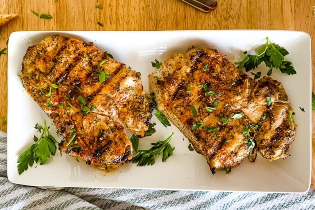 Buttermilk pork chops served on a white plate.