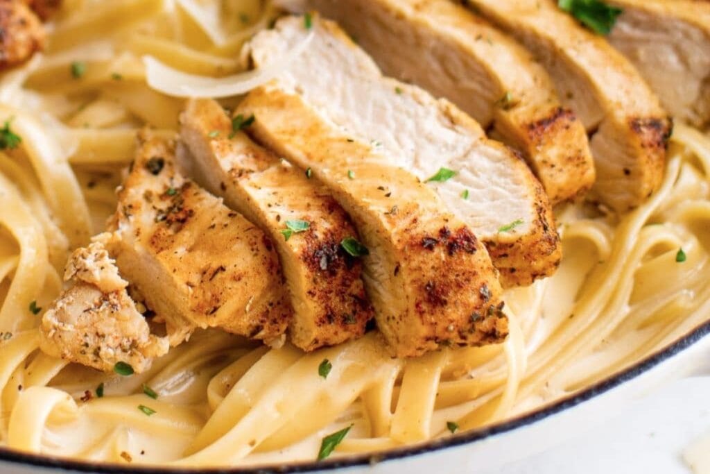 Close-up of chicken Alfredo on a plate.