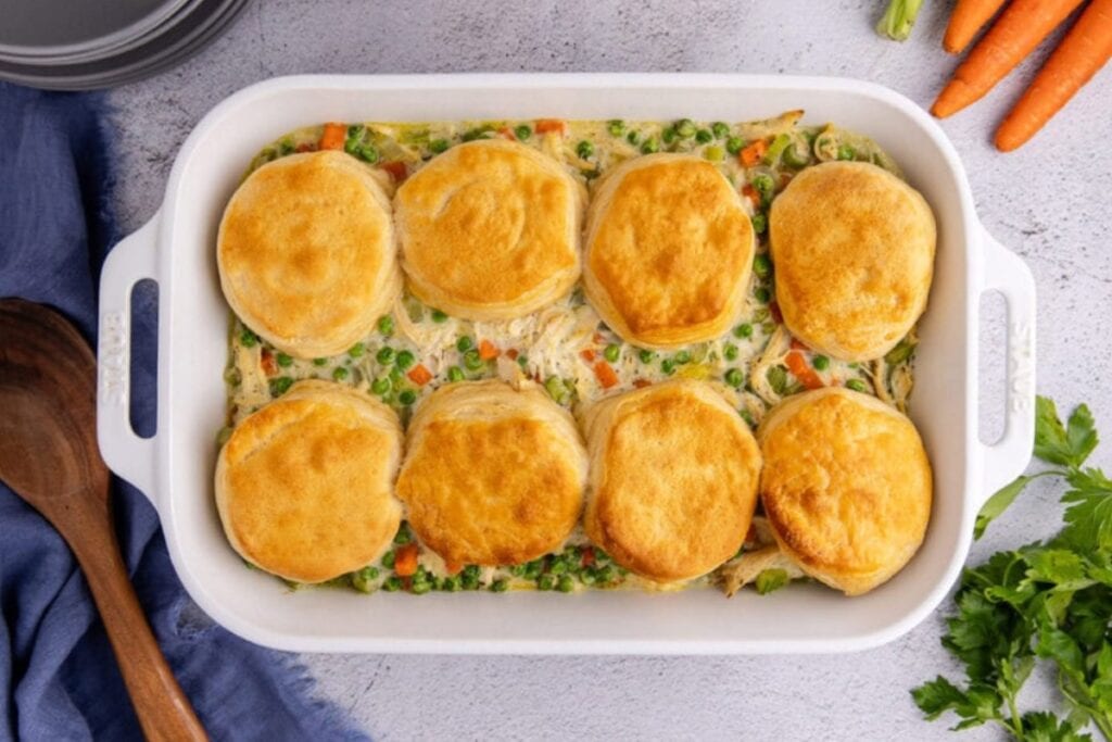 Chicken pot pie casserole in a white rectangular baking dish.