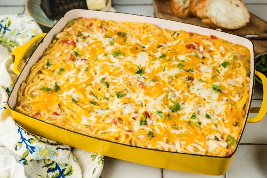 Chicken spaghetti casserole in a yellow baking dish.