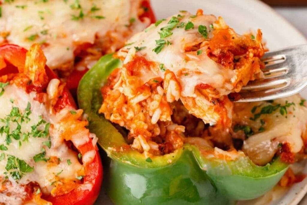 Close-up of chicken stuffed bell peppers being scooped with a fork.