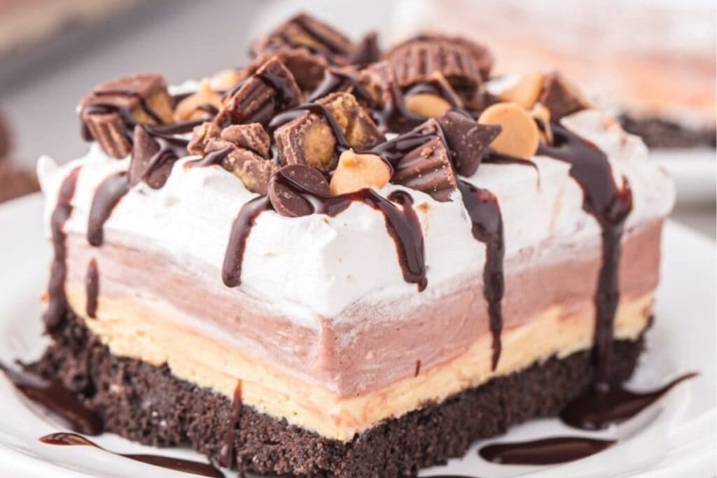 Slice of chocolate peanut butter lasagna on a white plate.