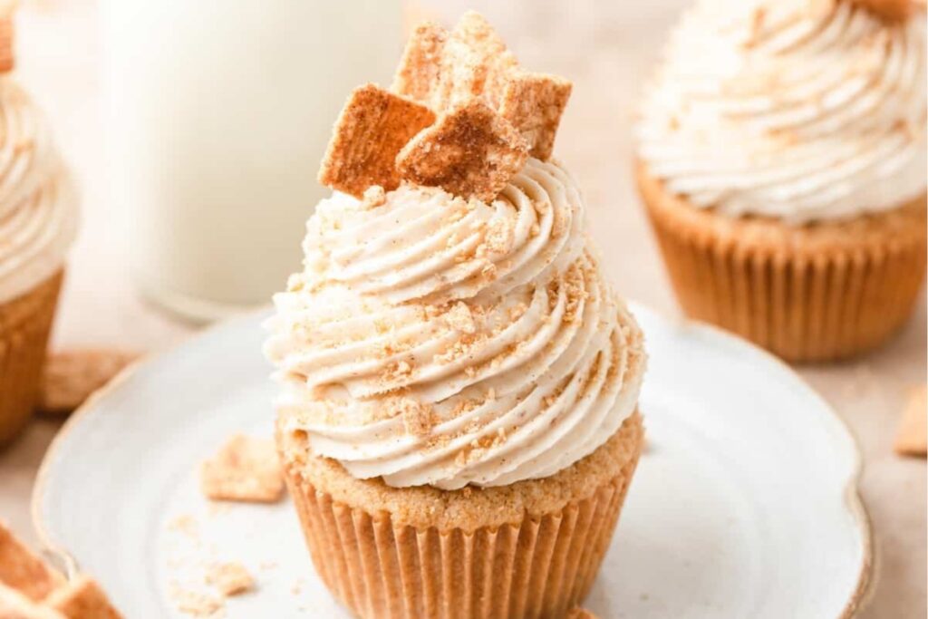 Cinnamon Toast Crunch Cupcakes on a white plate.