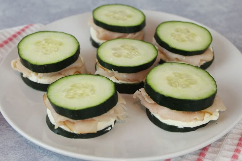 Cucumber sandwiches on a plate.