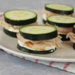 Cucumber sandwiches on a white plate.