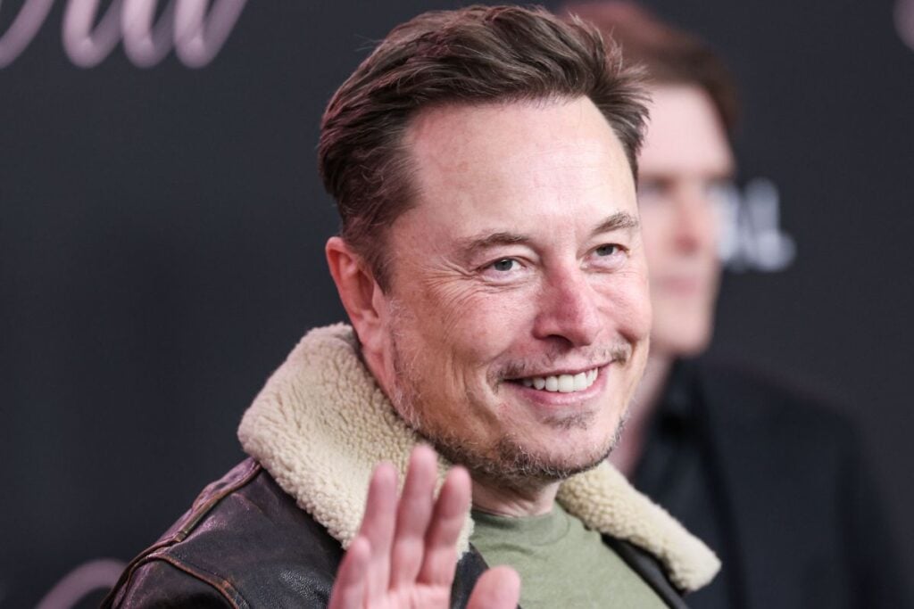 Elon Musk waving to camera.