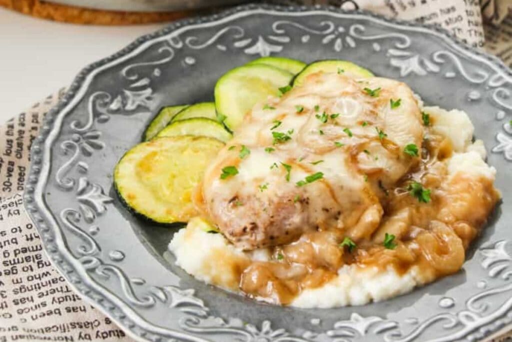 French onion pork chops served on a plate.