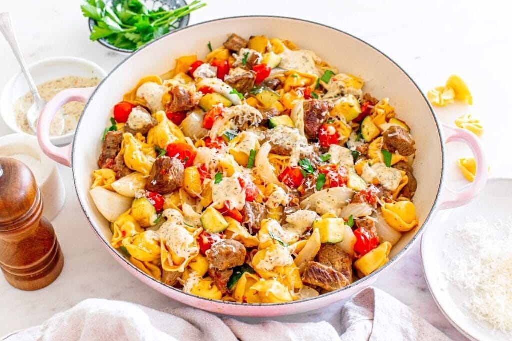Garlic Parmesan steak tortellini served in a white bowl.