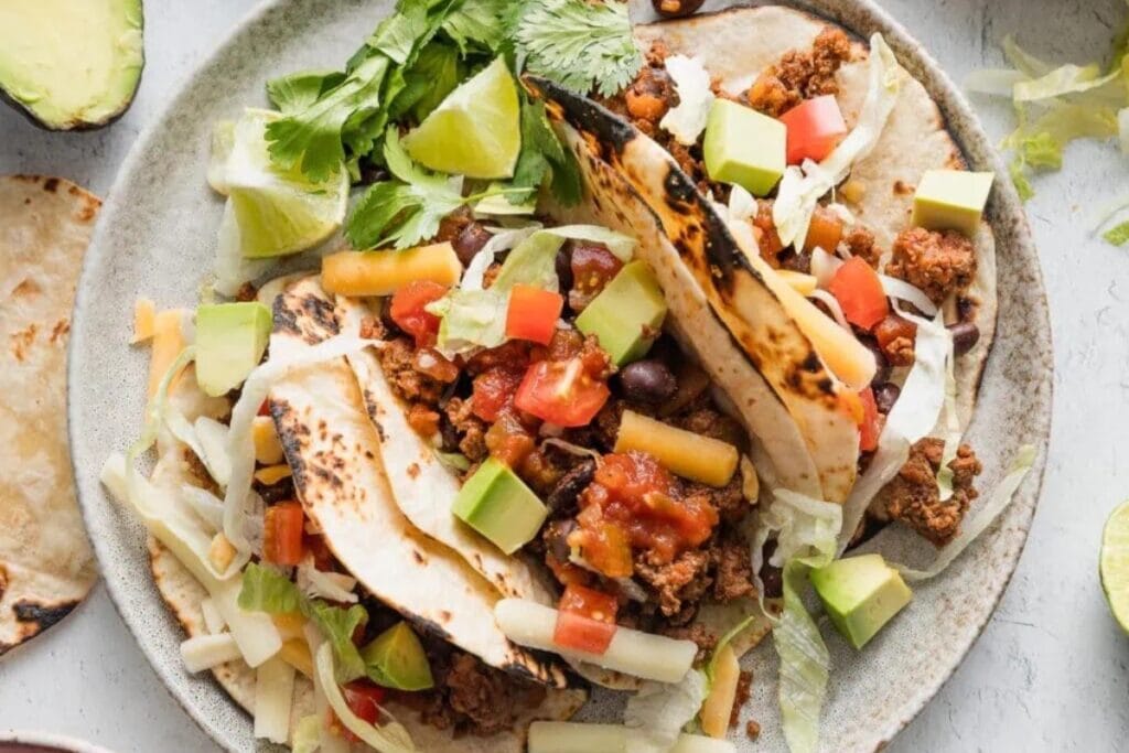 Ground beef and bean tacos on a plate.