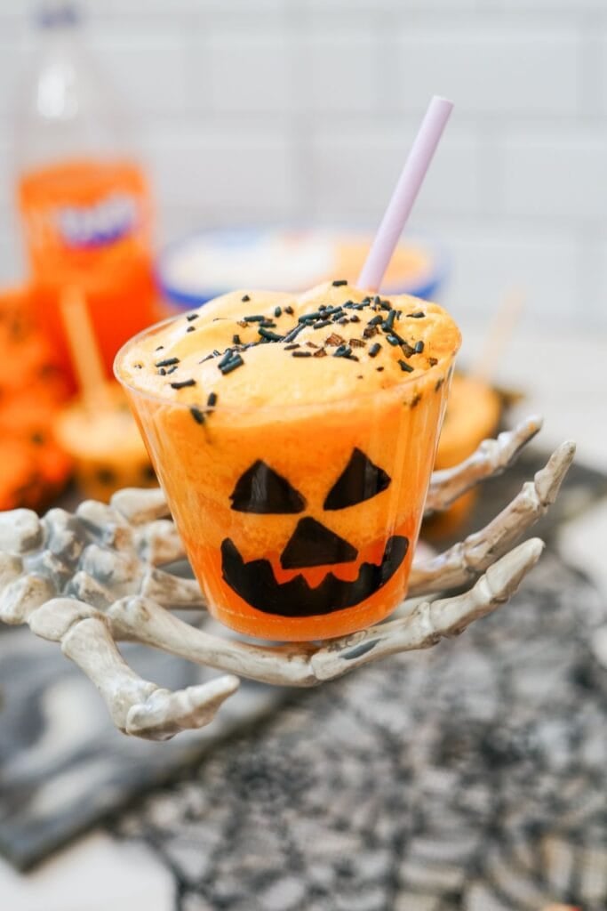 Jack o lantern float with orange sherbet in cup.
