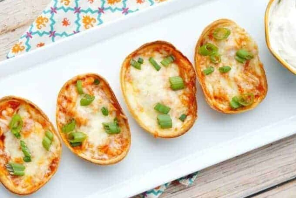 Mini chicken enchilada cups on a white plate.