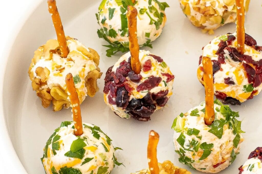 Mini cheese balls served on a white pasta bowl.
