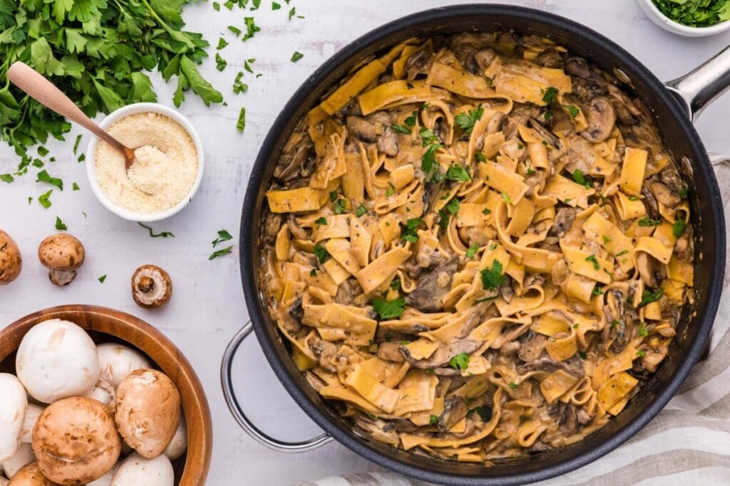 Mushroom stroganoff in a black skillet.