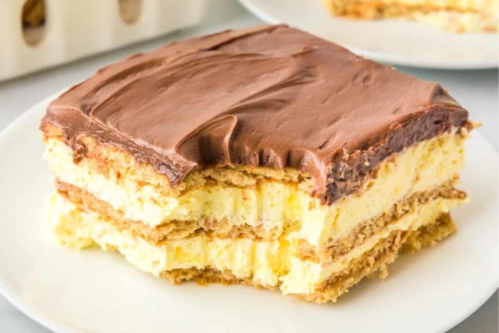 Slice of no-bake chocolate eclair cake on a plate.
