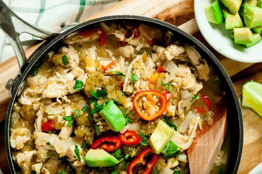 Salsa verde chicken in a skillet.