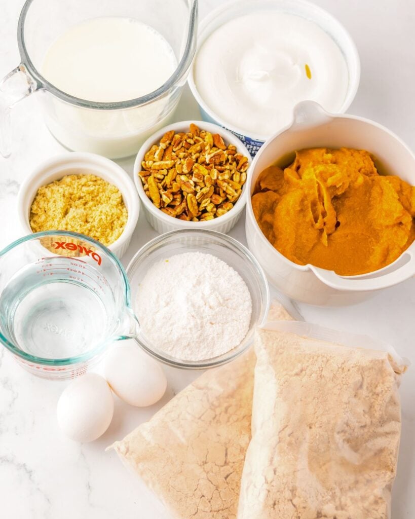Pumpkin gingerbread poke cake ingredients on a table.