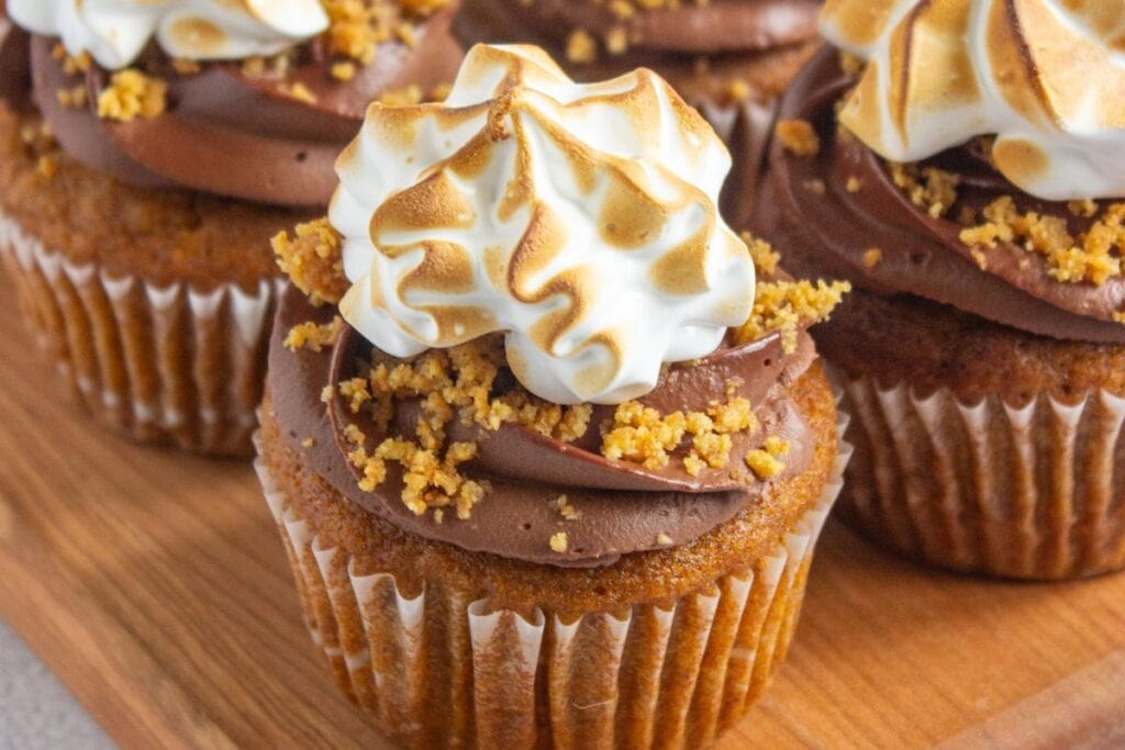 Pumpkin smores cupcakes on a wood board,