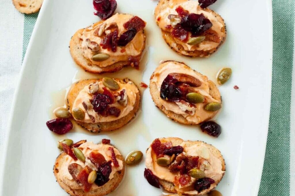 Pumpkin crostini arranged on a rectangular white plate.