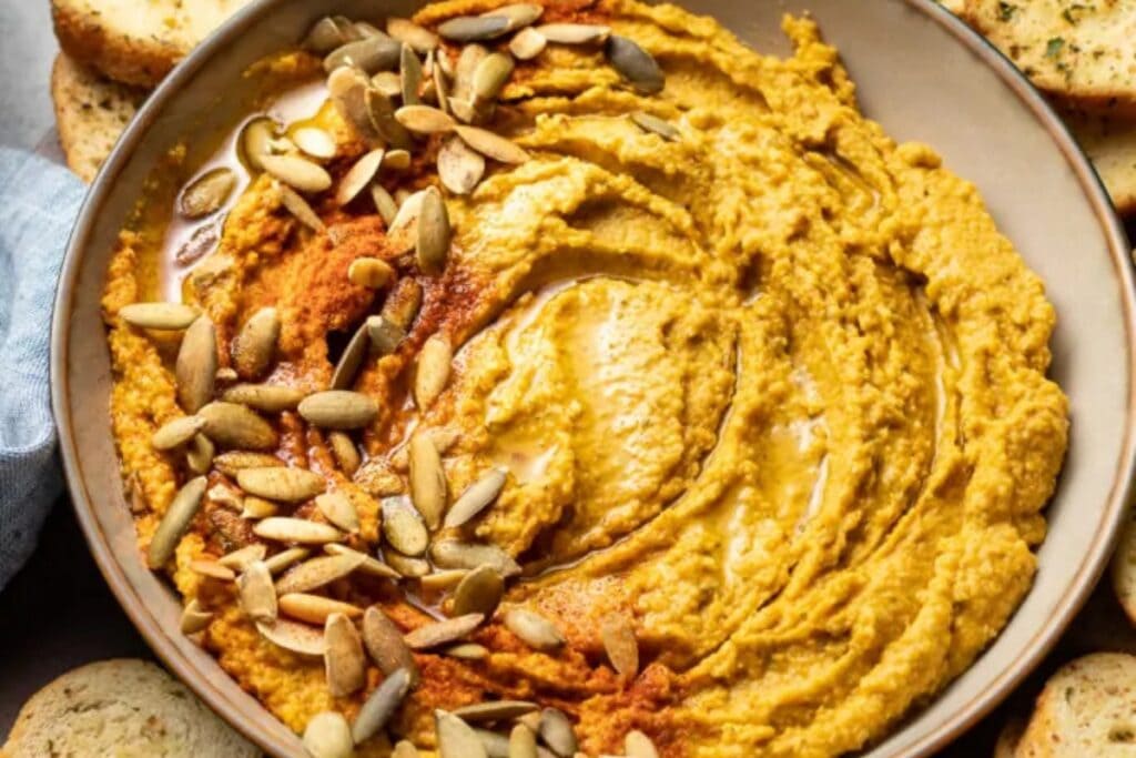 Roasted garlic sage pumpkin hummus in a bowl.