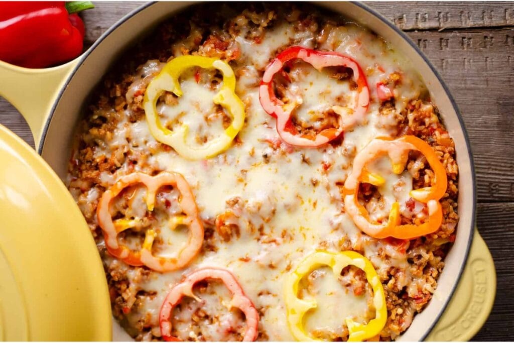 Top view of sausage stuffed pepper on a skillet.