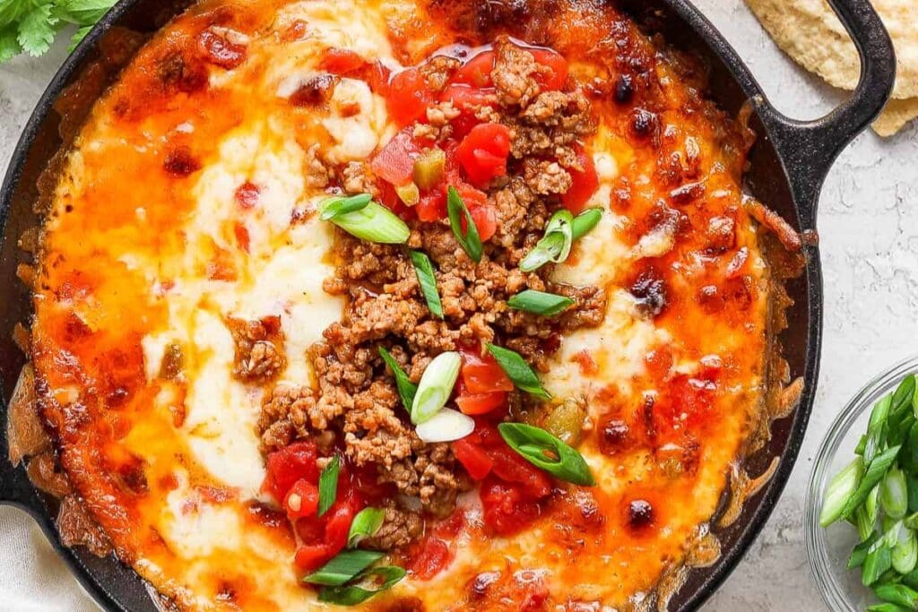 Smoked queso in a round black skillet.